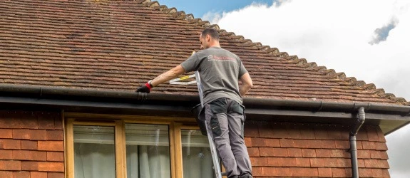 Gutter cleaning a residential property in Durham